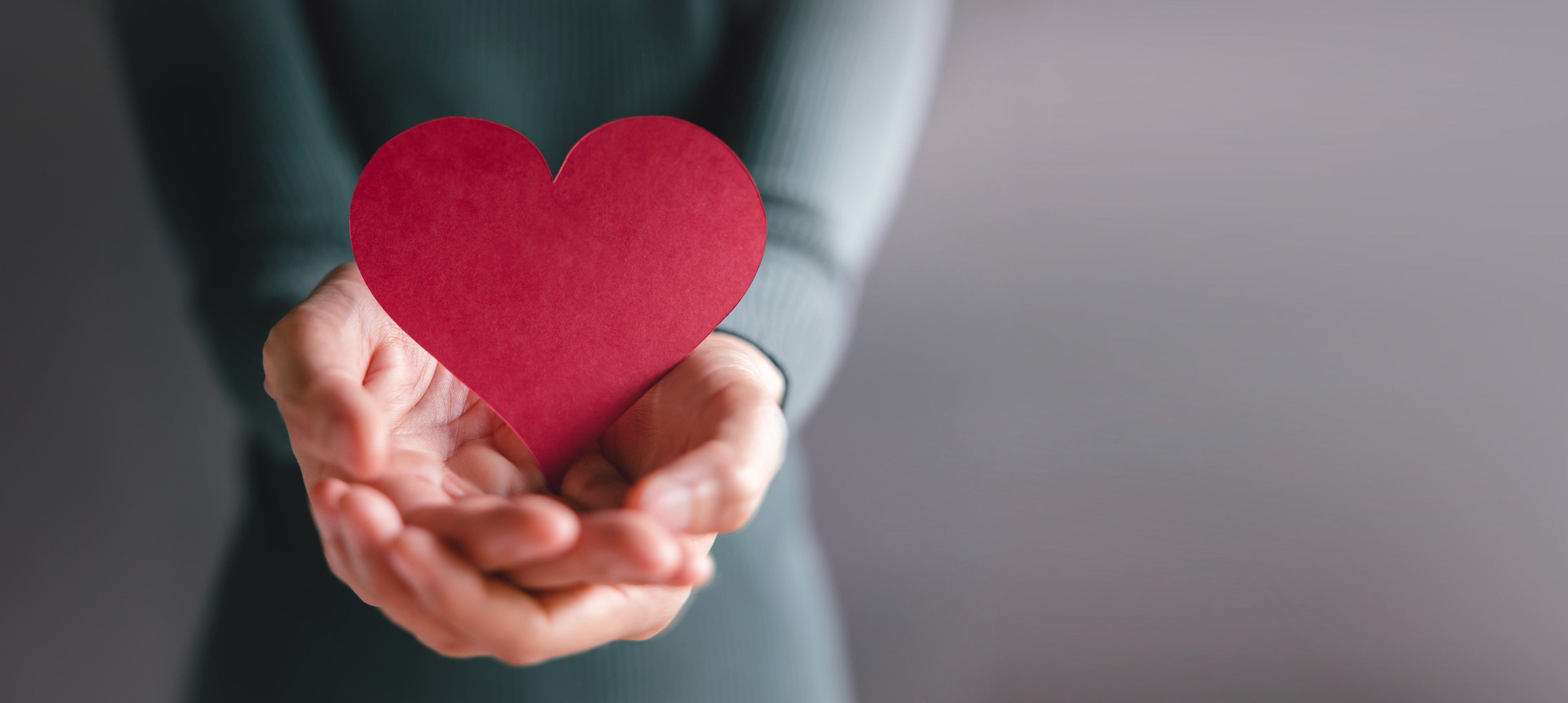 Volunteer Holding a Heart-Shaped Red Paper